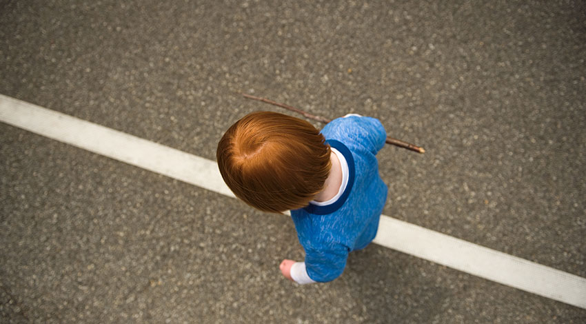 Child walking on a line
