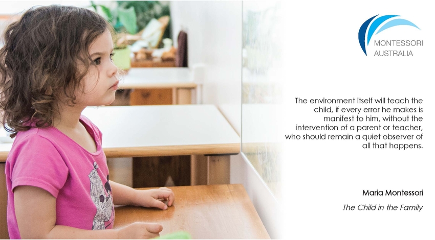 Young child focusing on picture on wall of Montessori classroom