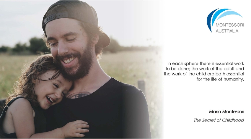 Girl in the arms of father in a field