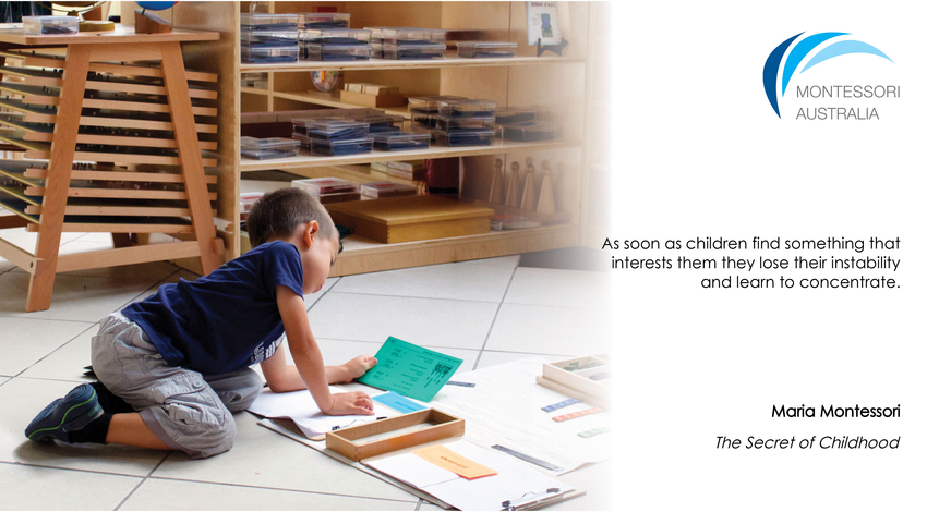 Boy in Montessori classroom on floor using materials