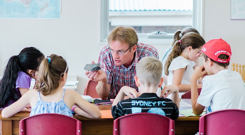 Cosmic education Montessori teacher with children